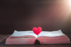 Picture of a heart coming out of a Bible on a table