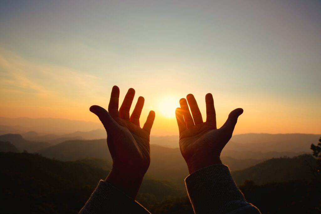 Hands reaching up in prayer